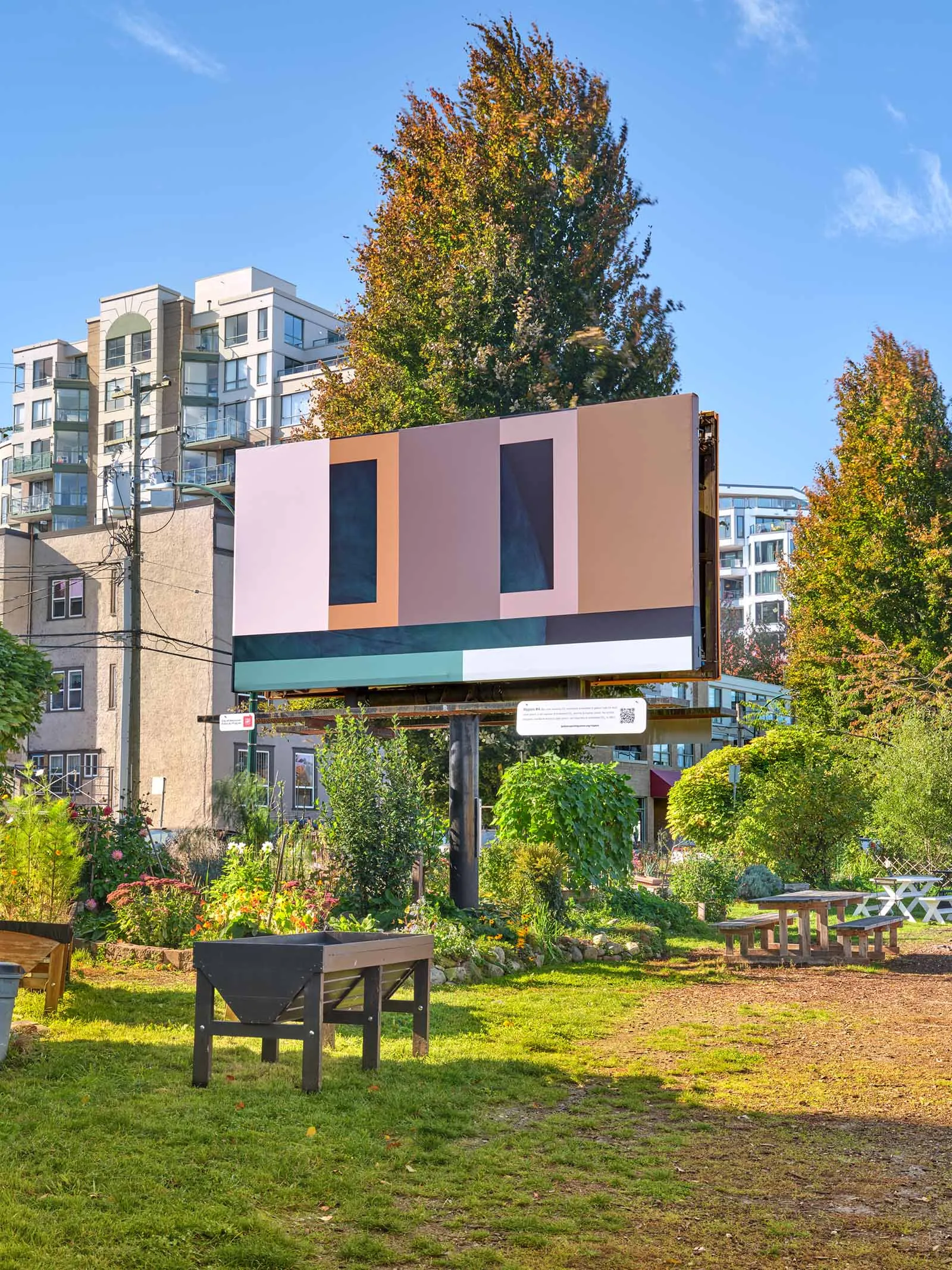 An art billboard set in a park-like setting.