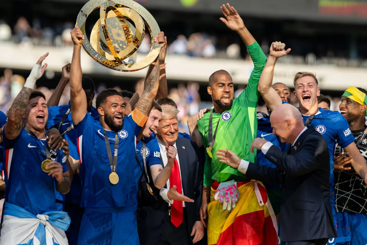 Chelsea FC players lift the FIFA Club World Cup trophy with U.S. President Donald Trump after the 2025 FIFA Club World Cup final at MetLife Stadium in East Rutherford, New Jersey on July 13, 2025.